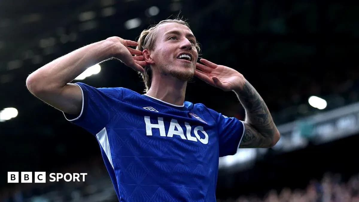 Player celebrating a goal with hands to ears