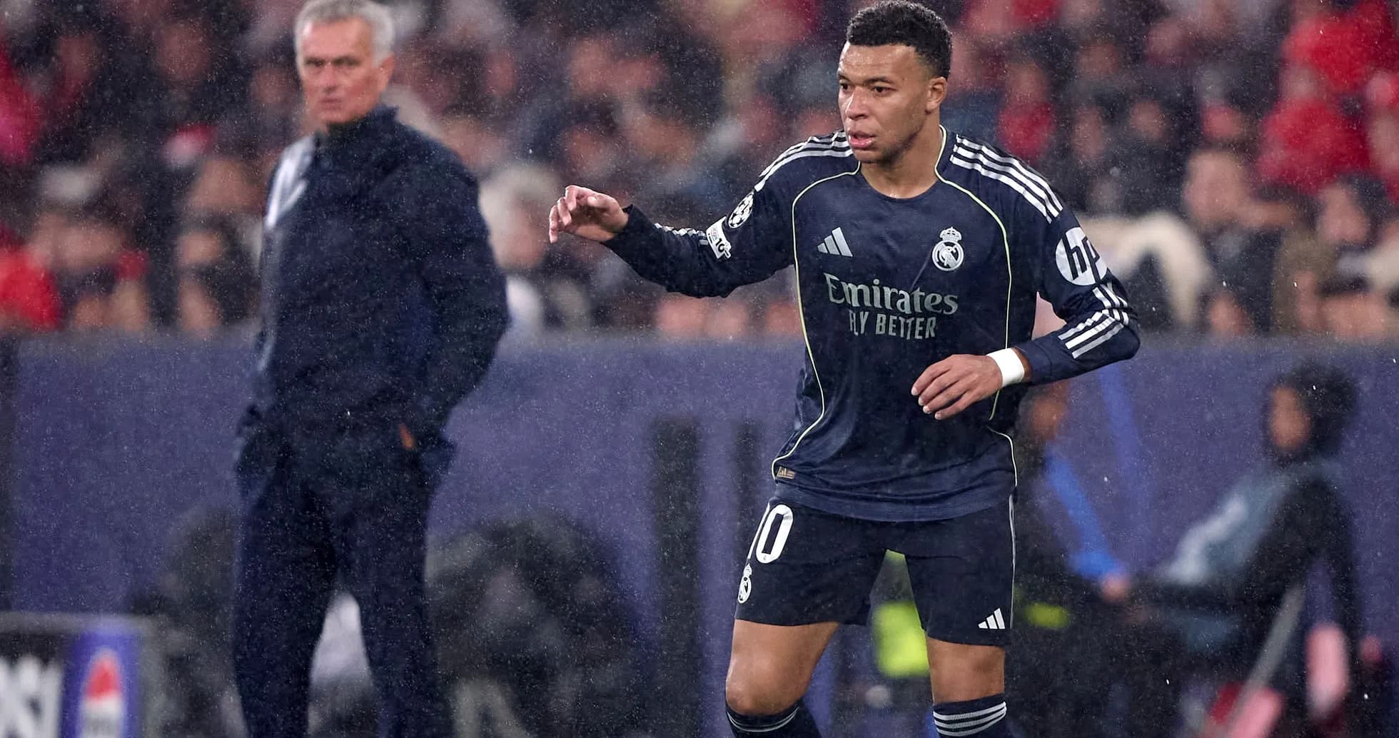 Player in Real Madrid kit during match with coach