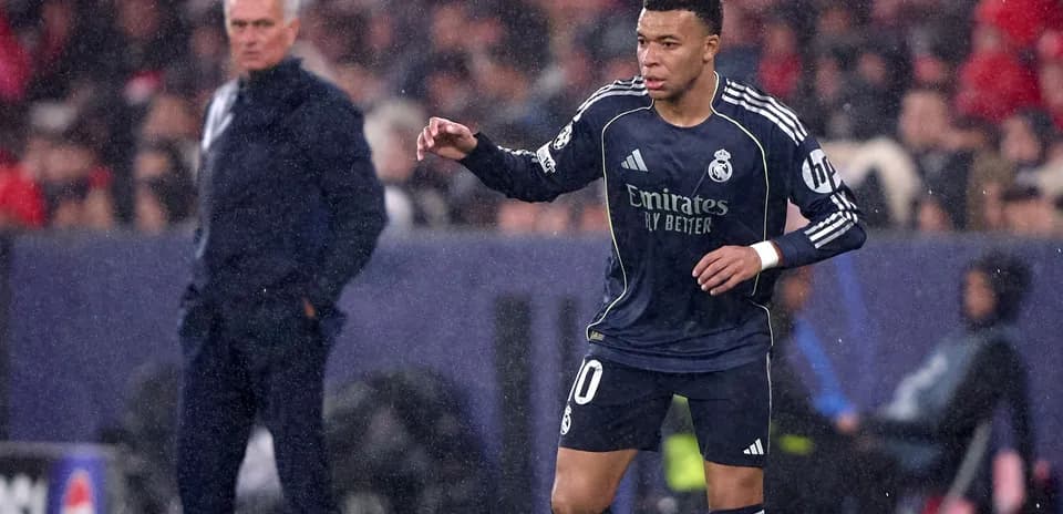 Player in Real Madrid kit during match with coach