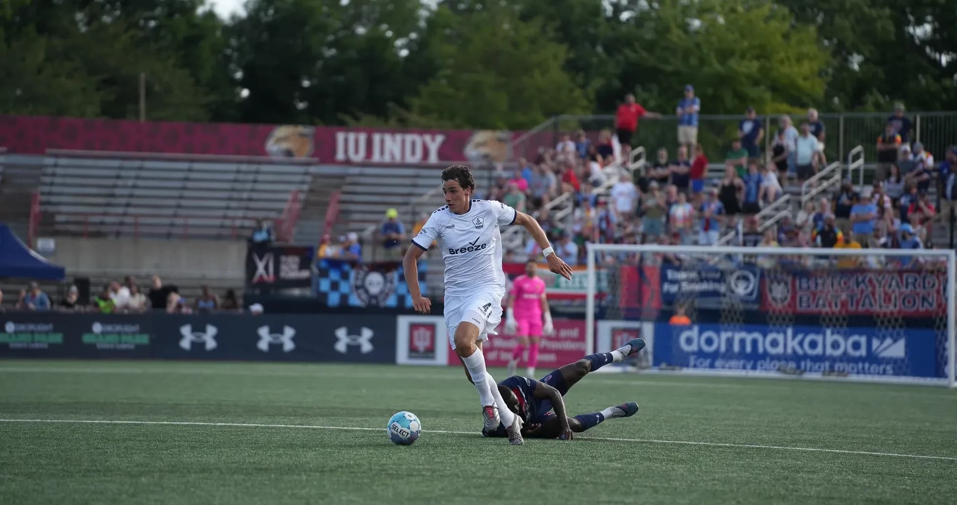 Player dribbling past opponent during USL match