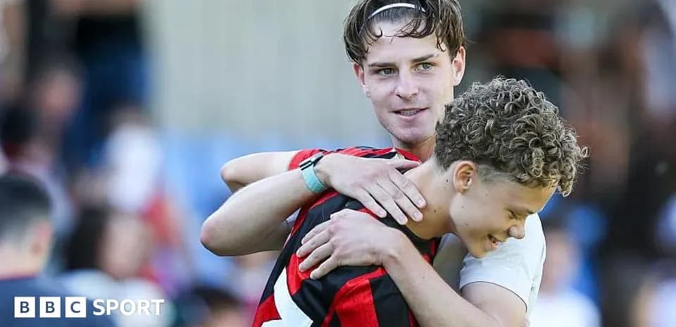 Two players embracing on the football pitch