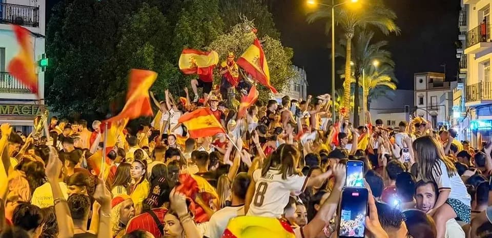 Crowd celebrating with flags in a night celebration