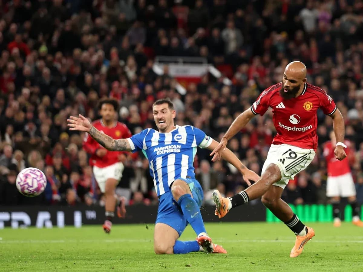 Brighton player tackling Manchester United forward