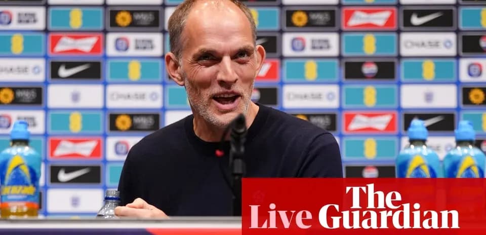 Coach at press conference with sponsor backdrop