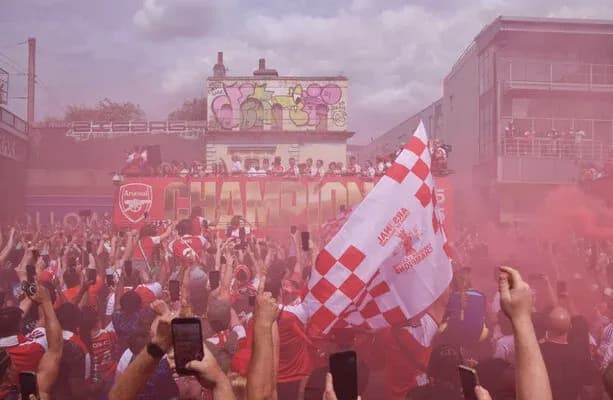 Arsenal fans celebrating with flares and flags