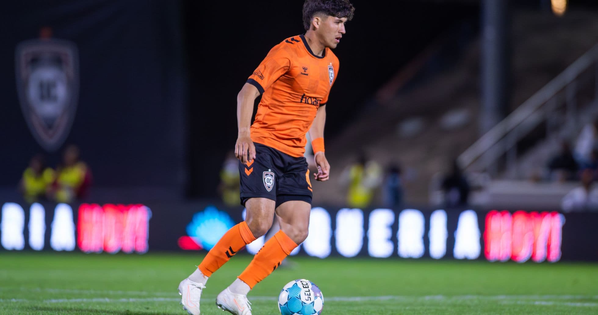 Orange County SC player dribbling the ball