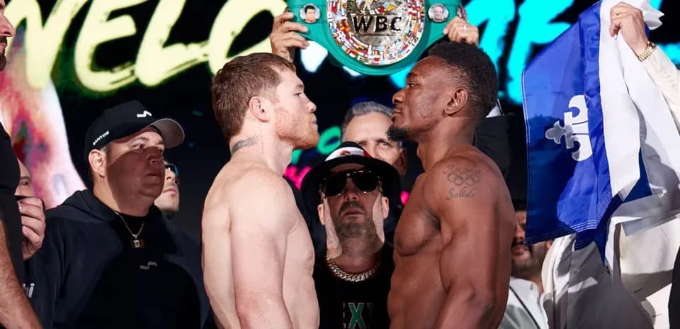 Boxers facing off at weigh-in with championship belt