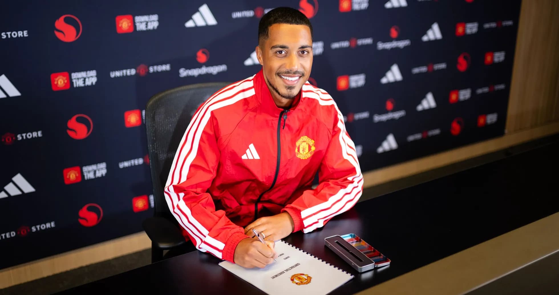 Player signing contract at Manchester United press event