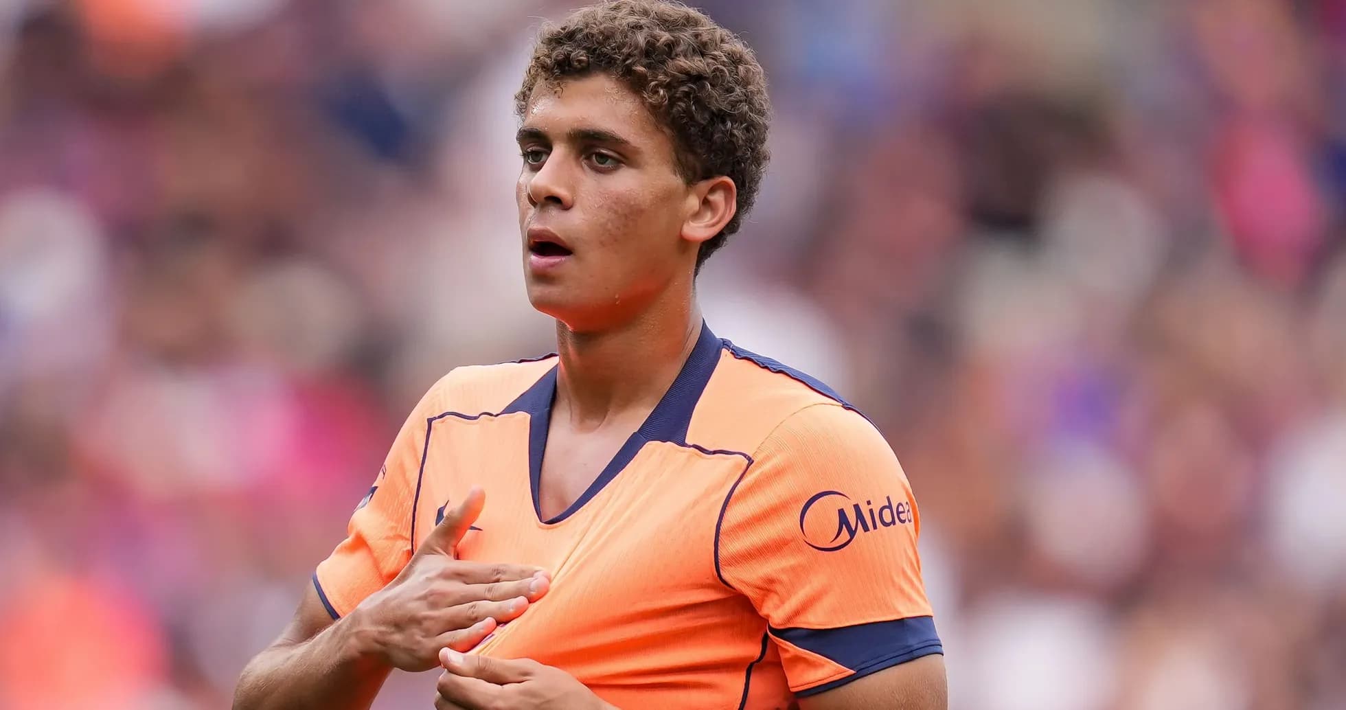 Player adjusting jersey during match warm-up