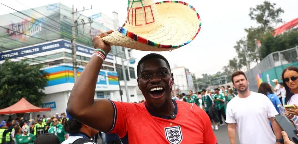 Fan wearing England jersey and sombrero at event