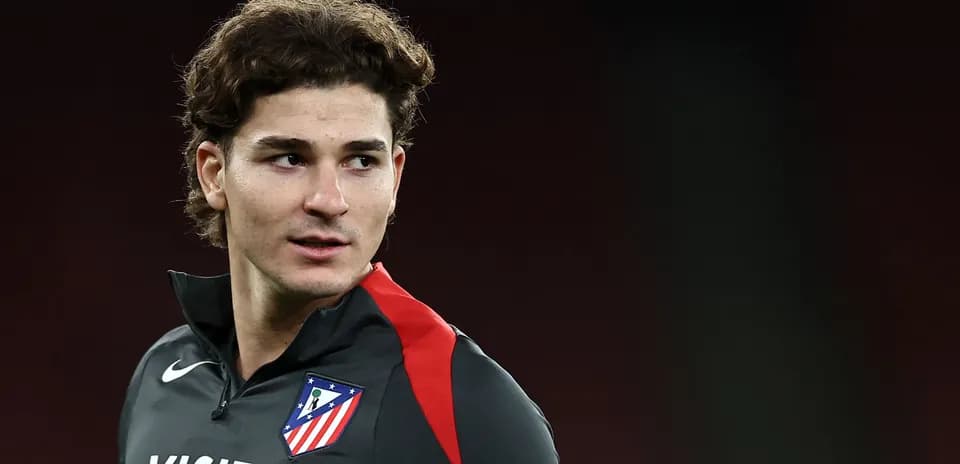 Player in Atlético Madrid training gear looking off camera