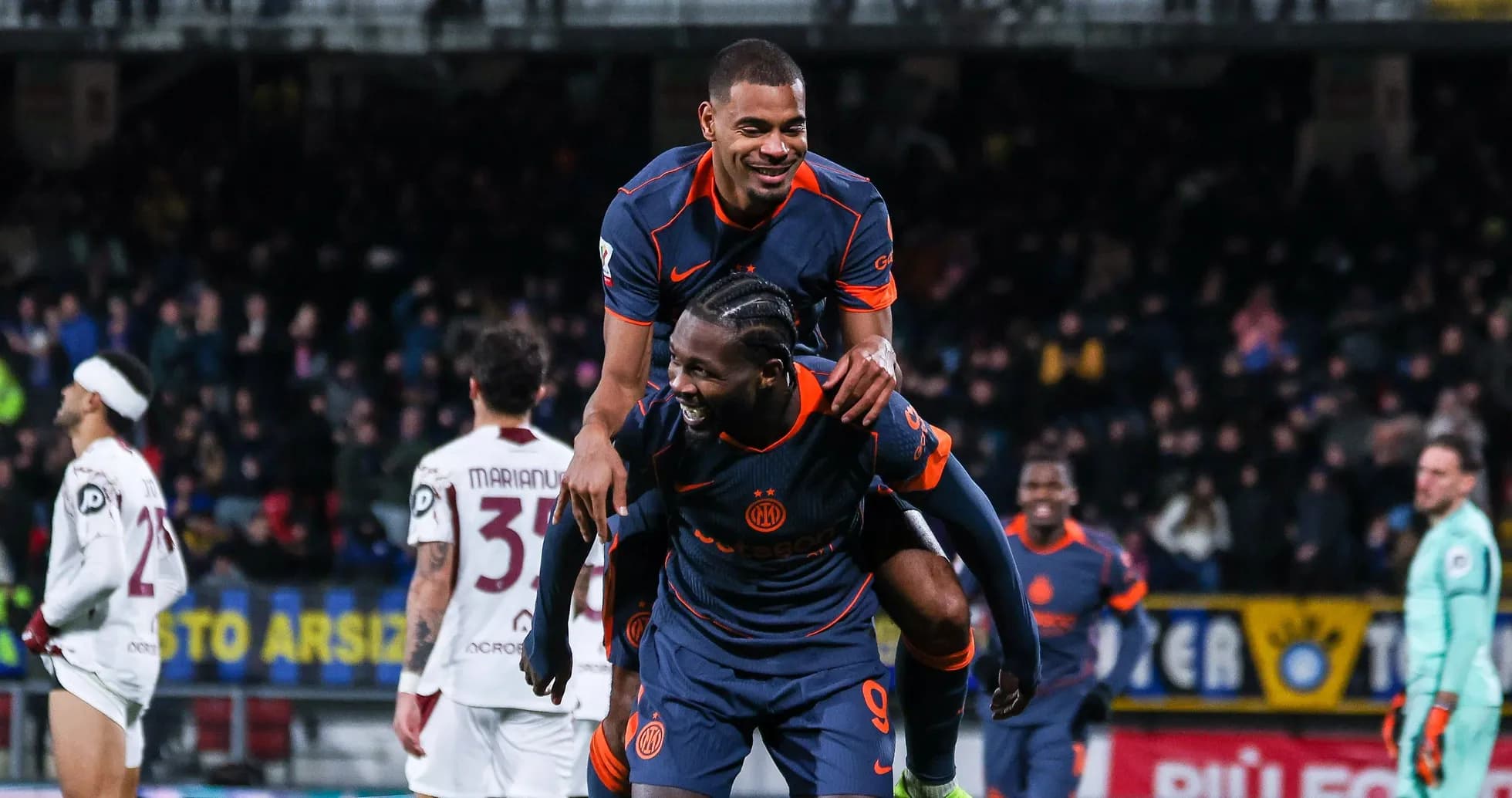 Two players celebrating a goal on the field