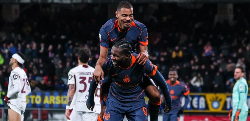 Two players celebrating a goal on the field