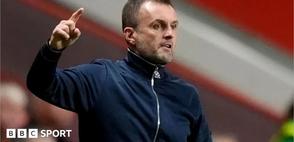 Coach gesturing during a match on the sideline