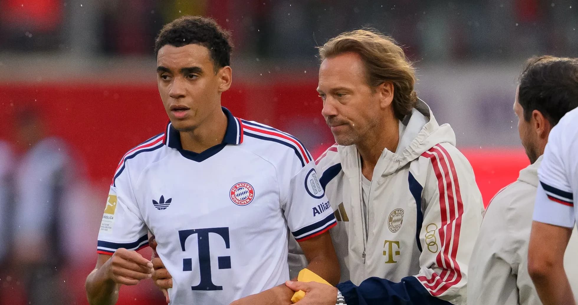 Player receiving instructions from coach on sidelines