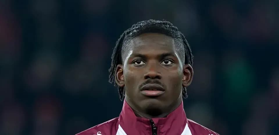 Player in team jacket during match warm-up