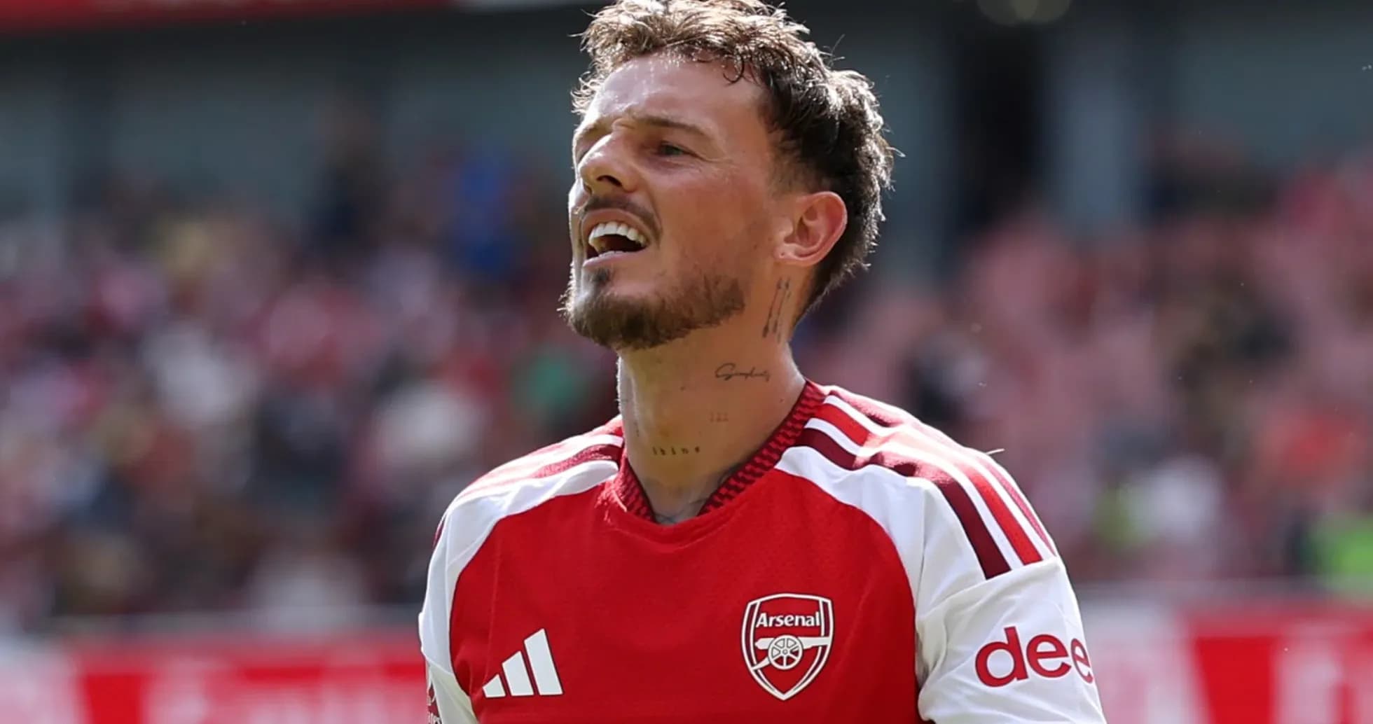 Player wearing Arsenal kit during match action