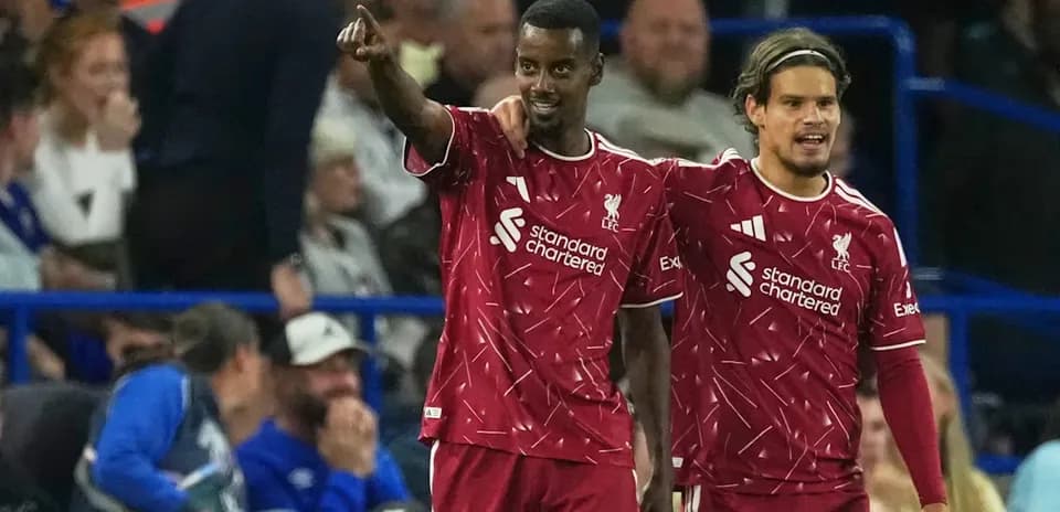 Two Liverpool players celebrating a goal on field