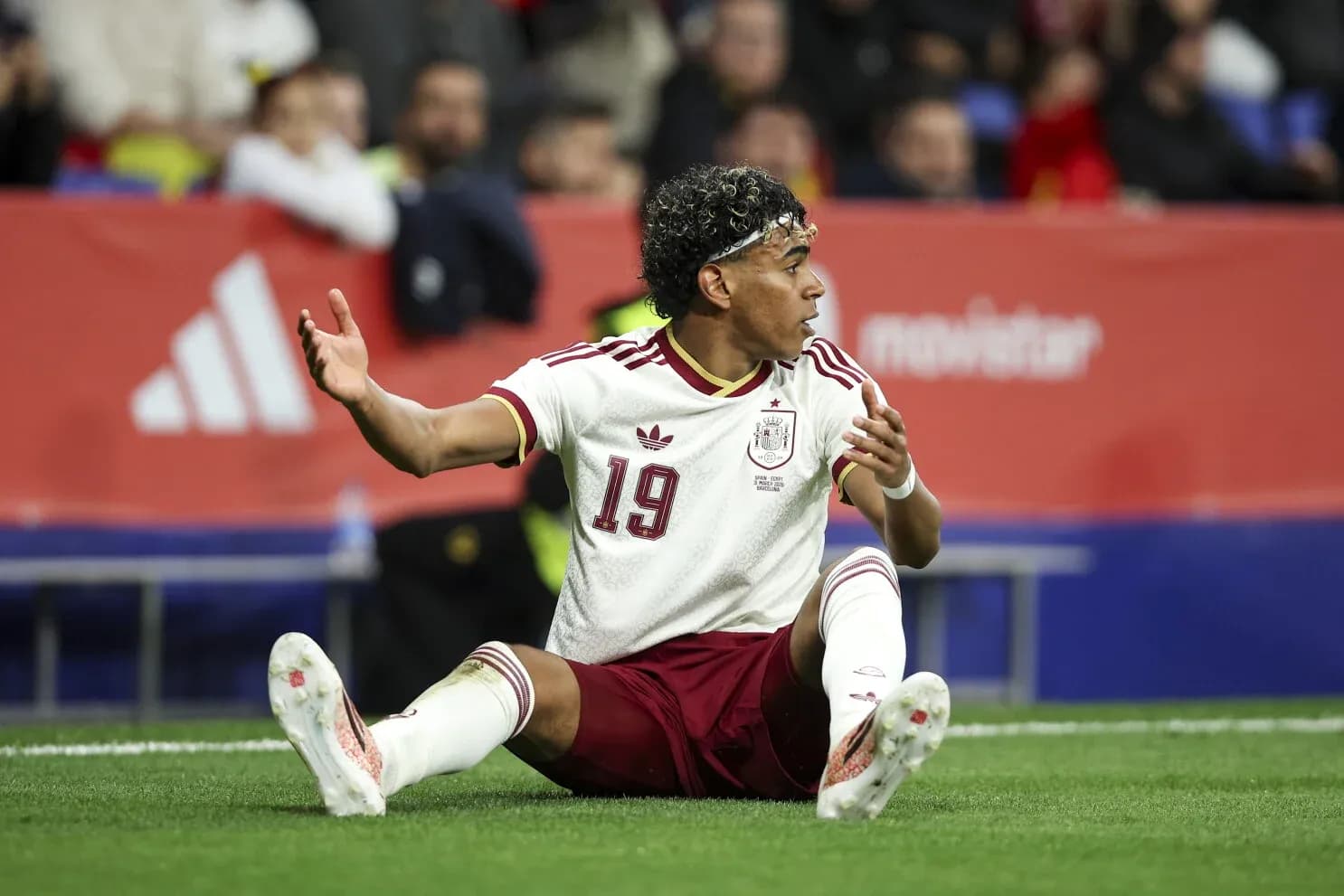 Player sitting on the field during Spain match