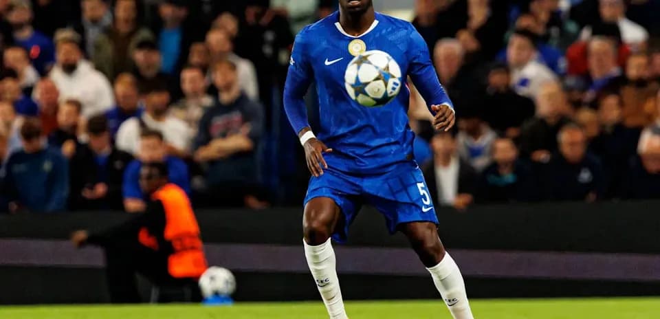 Player in blue kit controlling a soccer ball