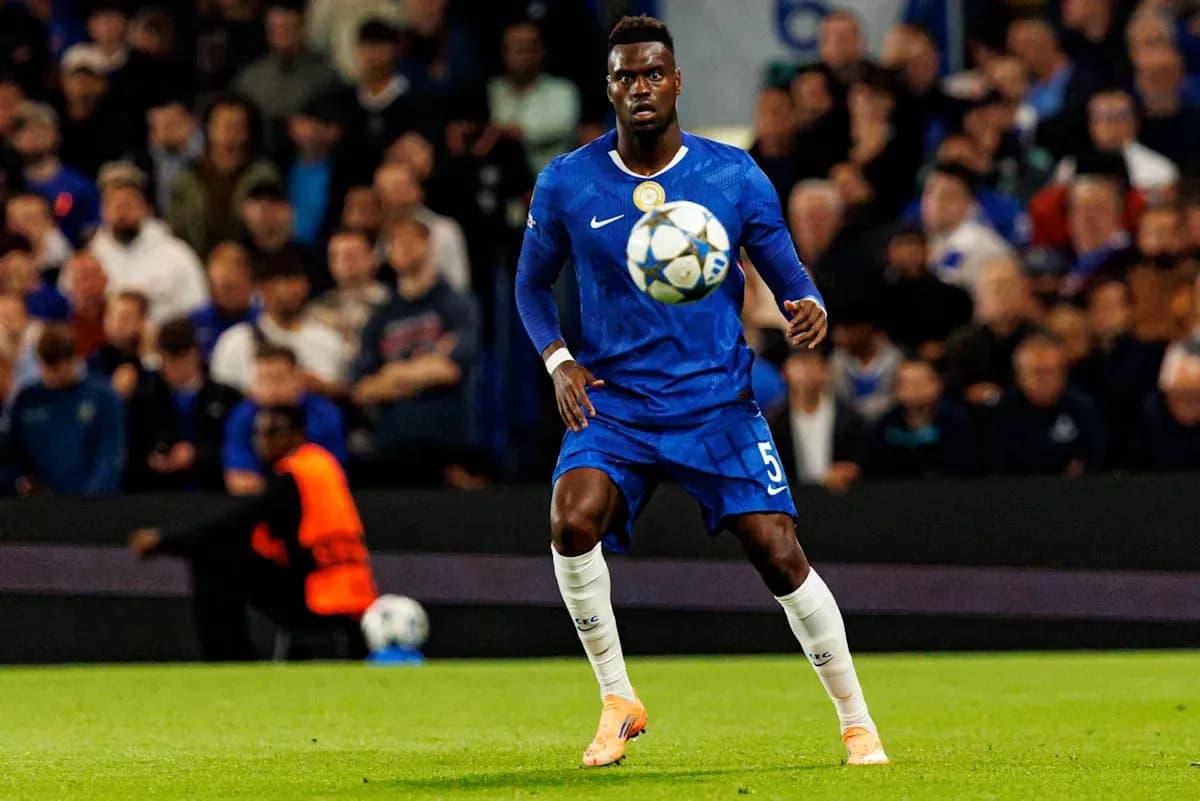 Player in blue kit controlling a soccer ball