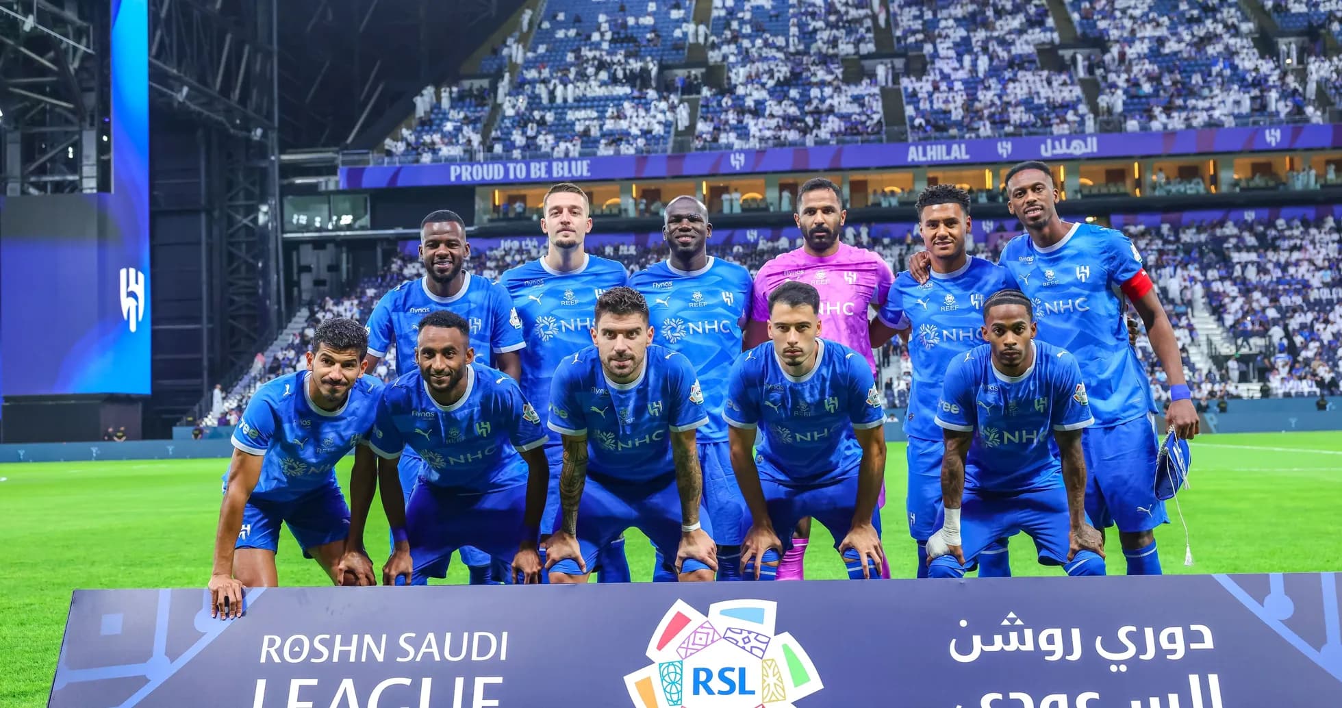 Al Hilal team posing for a group photo on pitch