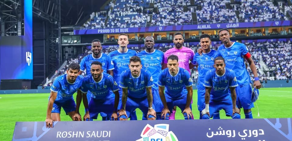 Al Hilal team posing for a group photo on pitch