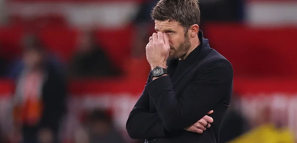 Coach observing match with hand on face