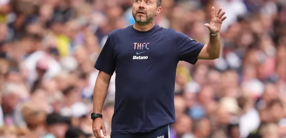Coach gesturing during a match at stadium