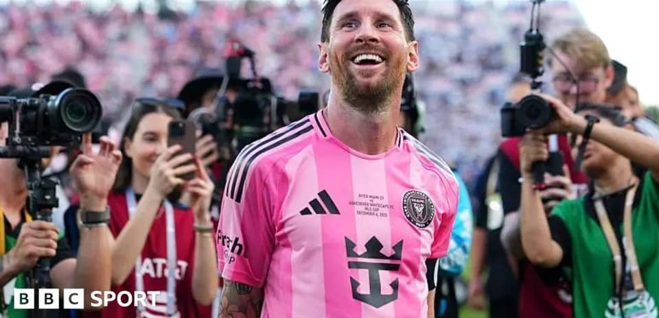 Lionel Messi smiling in pink Inter Miami jersey
