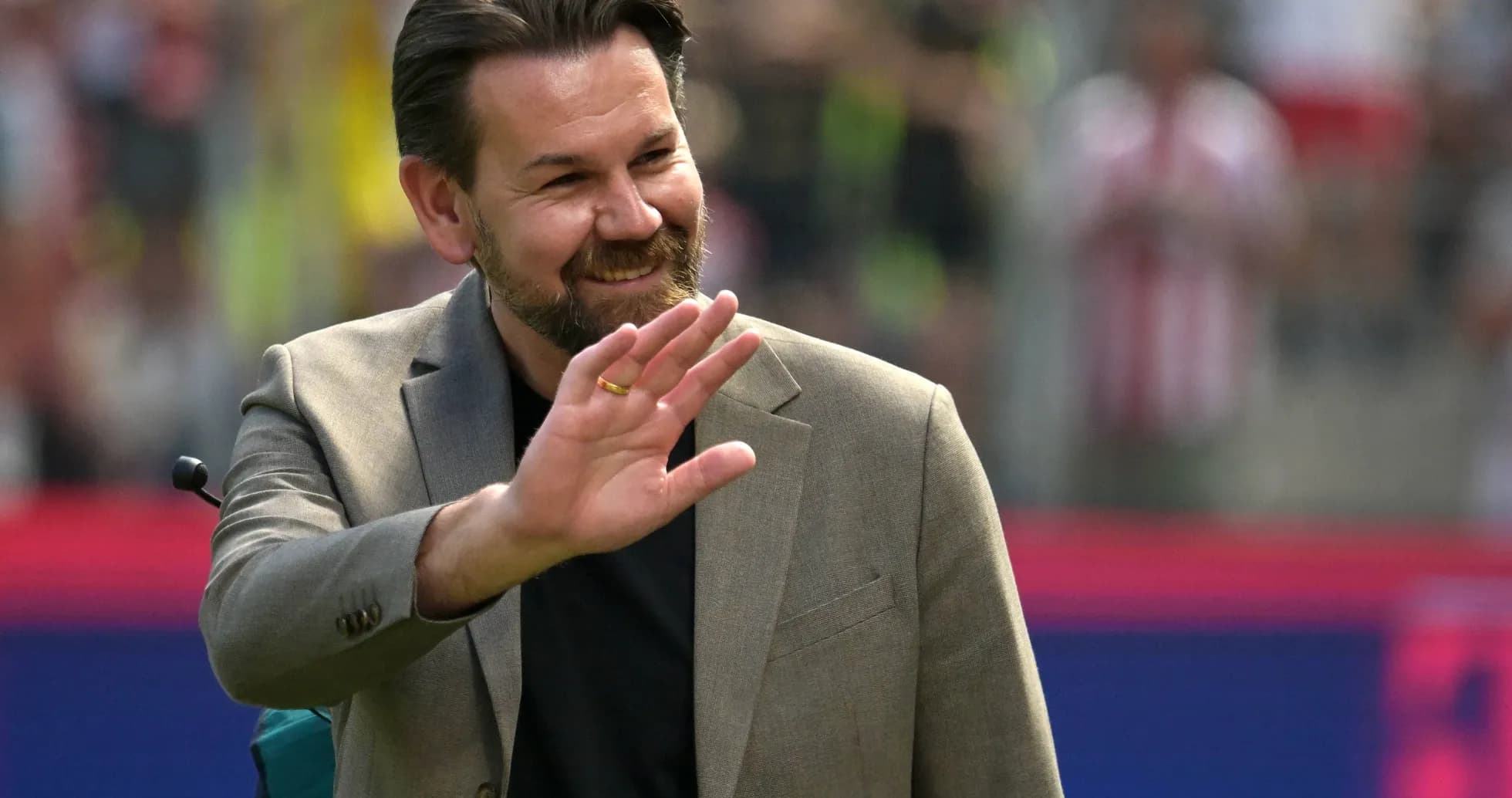 Man waving during a sporting event