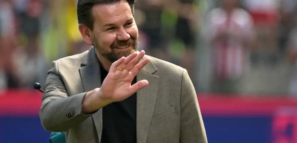 Man waving during a sporting event