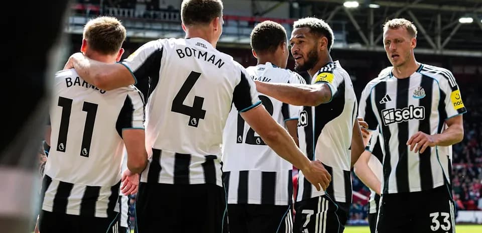 Newcastle players celebrating a goal together