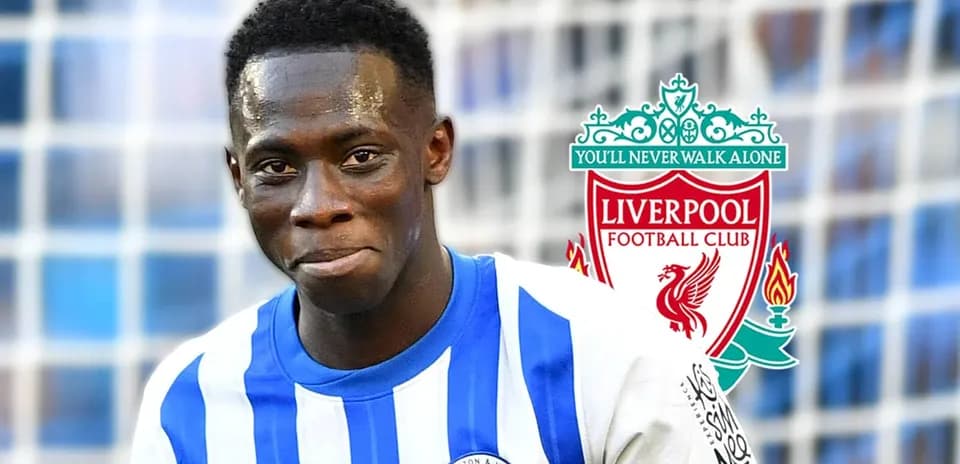 Player in Brighton kit with Liverpool logo background