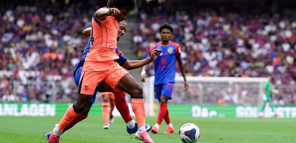 Player in orange tackling opponent in blue during match