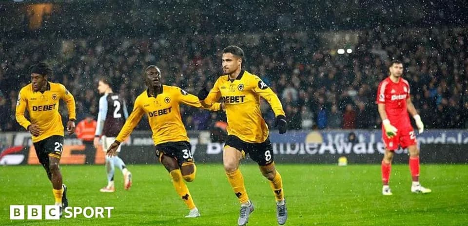 Player celebrating goal during match in rain