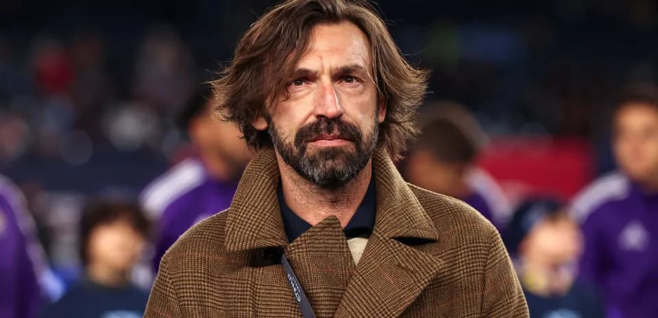 Man with long hair wearing a brown coat