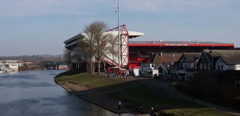 City ground stadium by the river with crowds
