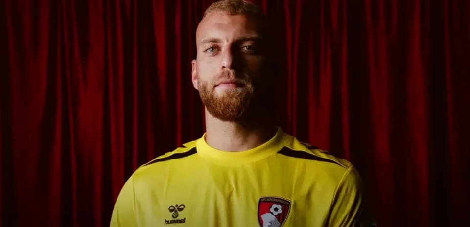 Goalkeeper in yellow jersey with AFC Bournemouth logo
