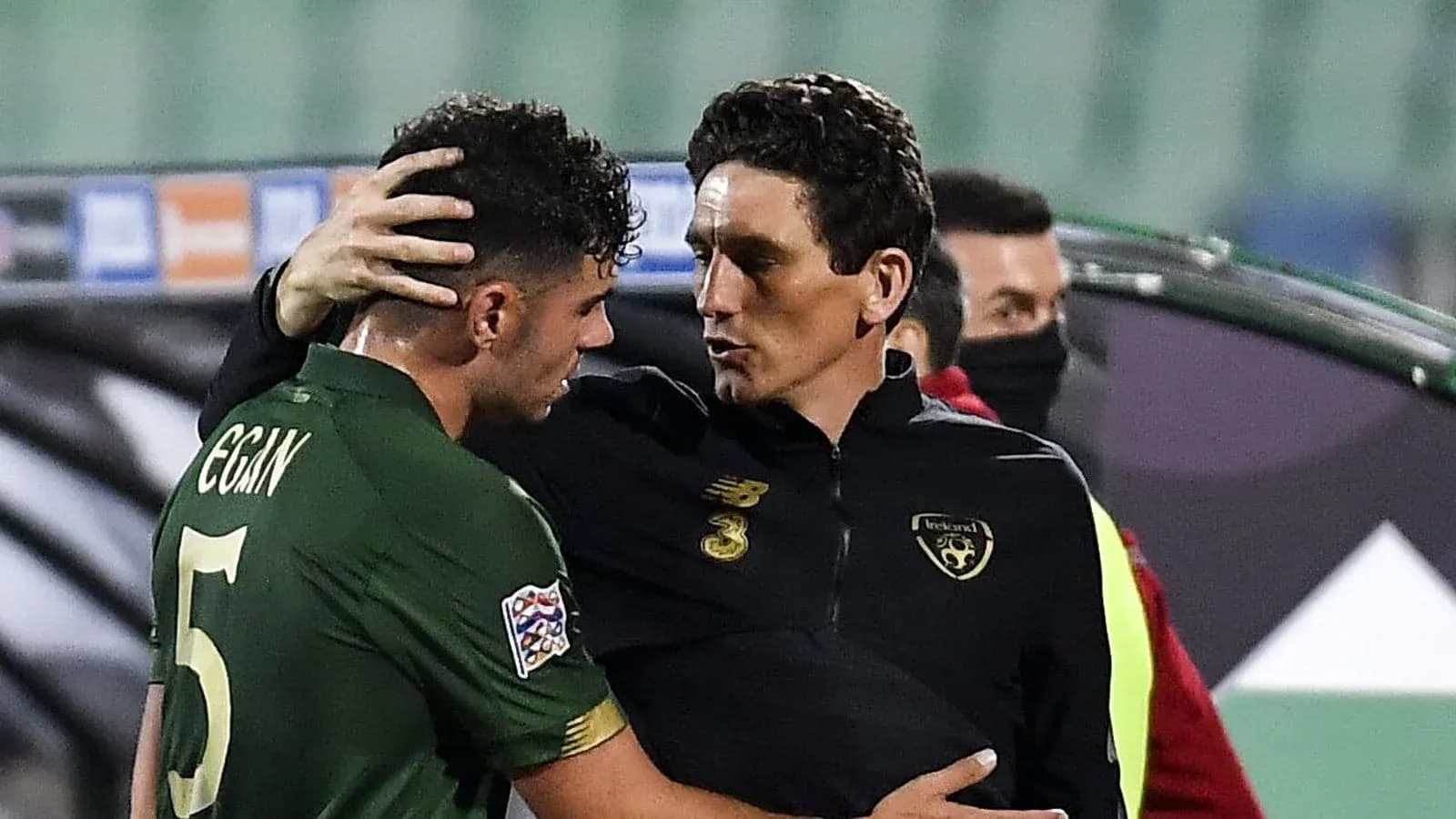 Player and coach in conversation after the match