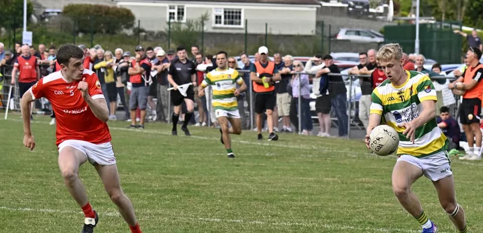 Player in green and yellow jersey receiving the ball