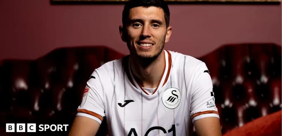 Player in Swansea City kit posing for photo