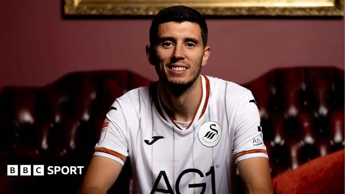 Player in Swansea City kit posing for photo