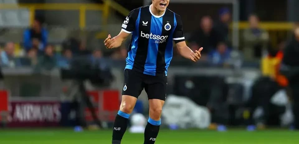 Player gesturing during match in blue and black kit