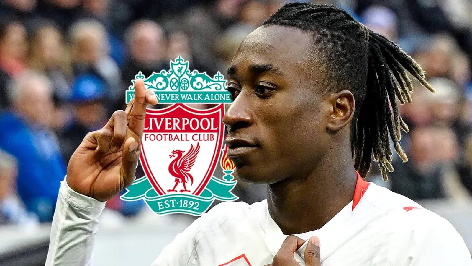 Player gesturing with Liverpool FC logo in background