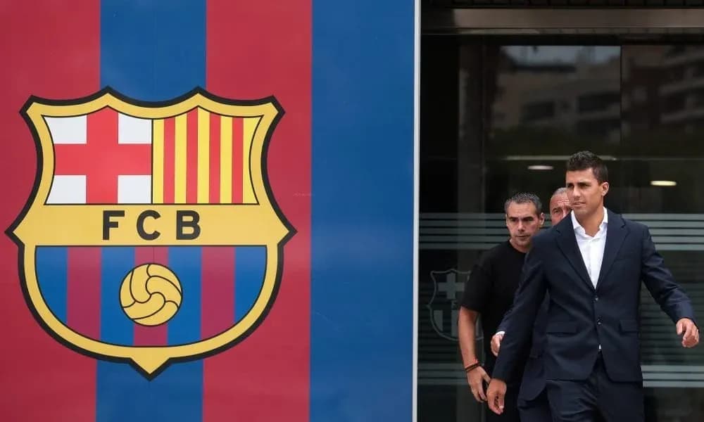 Player leaving FC Barcelona facility in formal attire