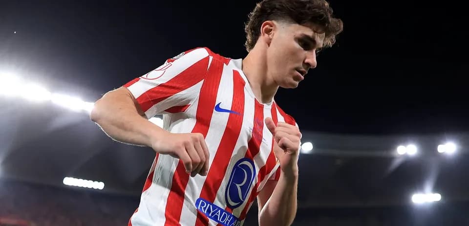Player in red and white kit celebrating on field