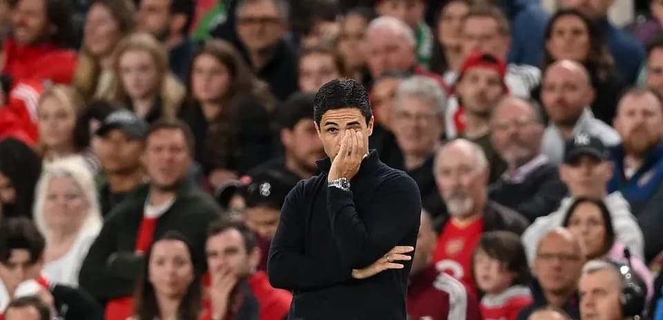 Coach observing the game with fans in background