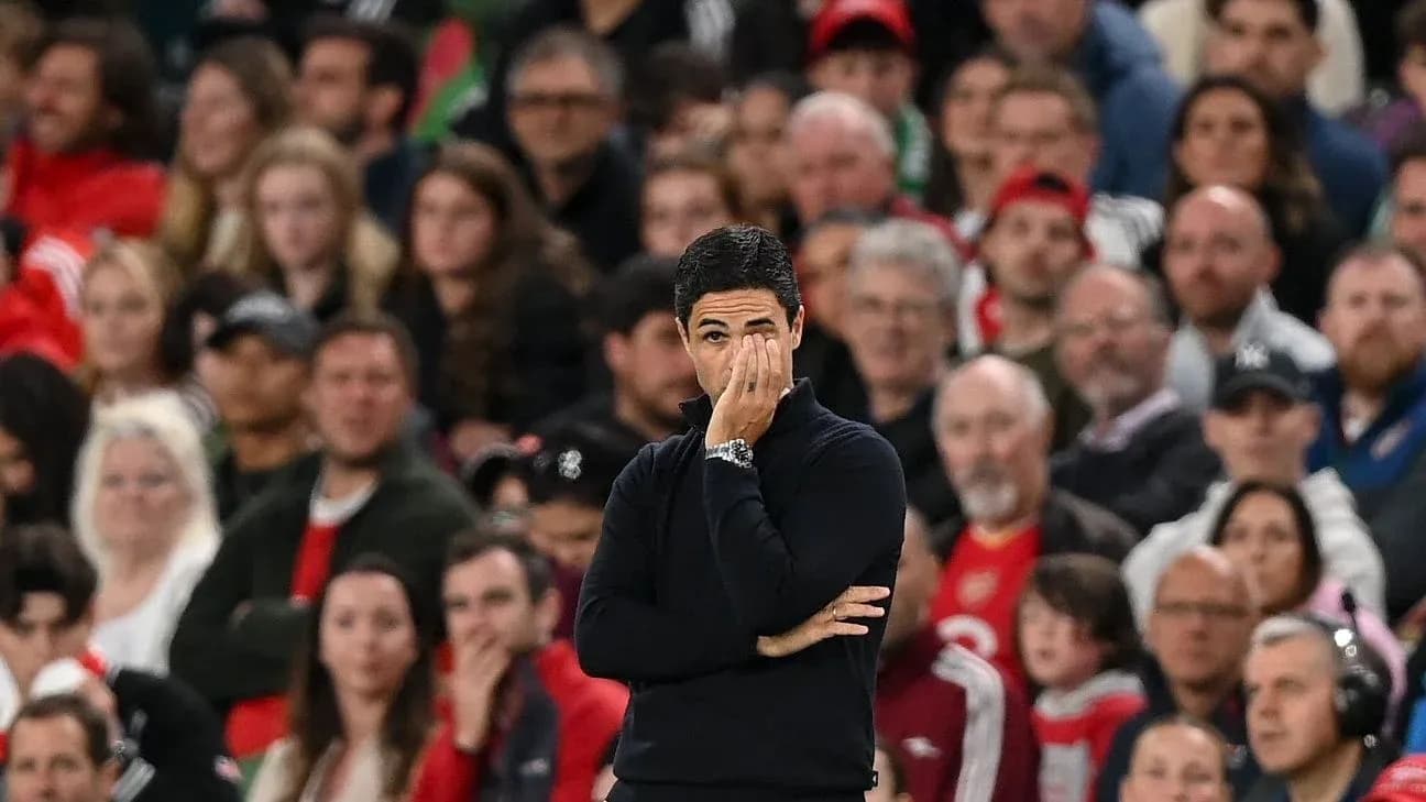 Coach observing the game with fans in background