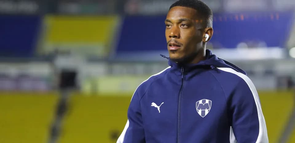 Player wearing headphones during warm-up on pitch